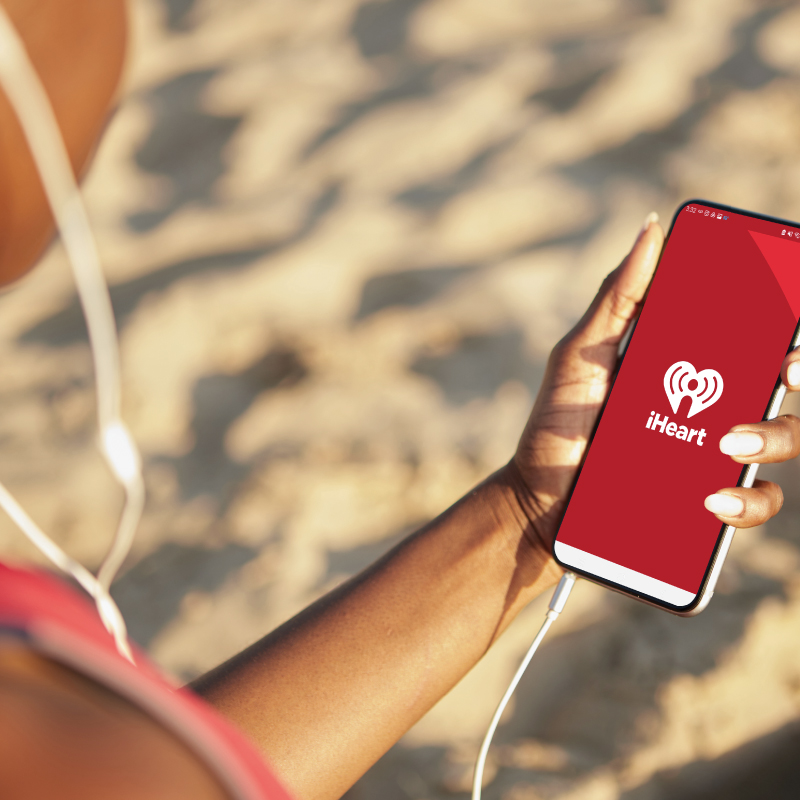 Person listening to audio ad on mobile device.